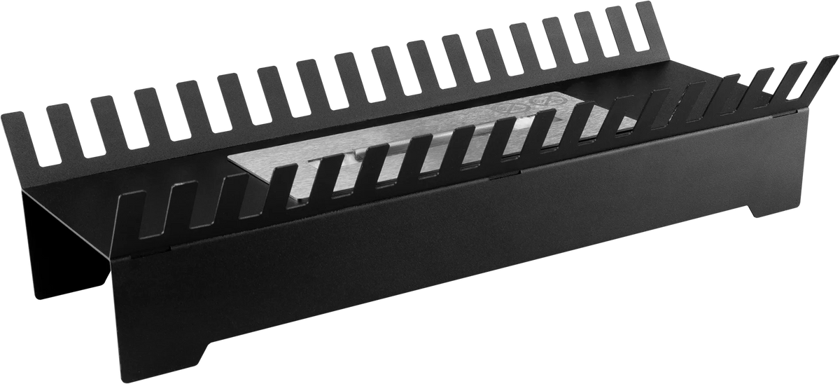 Angled view of the black FENIKS bioethanol insert with raised slotted sides and its burner visible