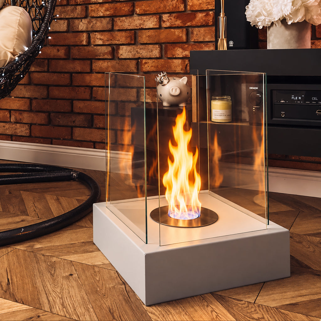 MAX Sunset Garden grey bioethanol fireplace with a lit flame beside a brick wall and dark media cabinet