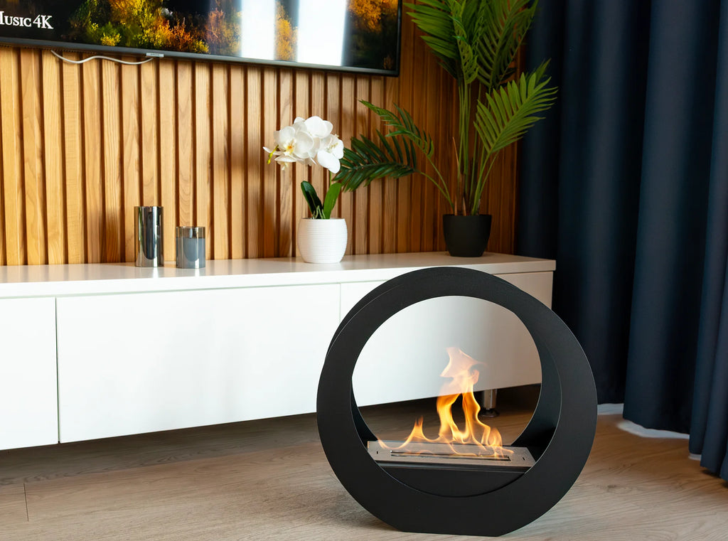 ONLY black circular bioethanol fireplace in a living room with a wooden slat wall, white cabinet and dark curtains