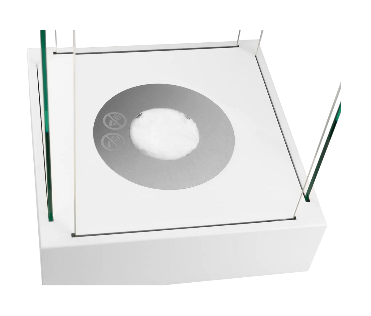 Close-up of the Sunset Garden Mini stainless steel burner with ceramic wool inside the white fireplace base