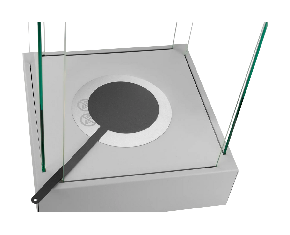 Close-up of the Sunset Garden Mini grey fireplace with the black flame snuffer covering the burner